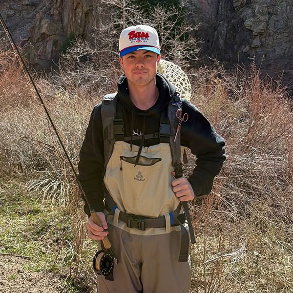 Guide, Grant Keck, in fly fishing waders, rod, reel, and net ready to go fishing.