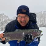 A very happy Richard Presnel holds a huge catch of a trout in the snow.