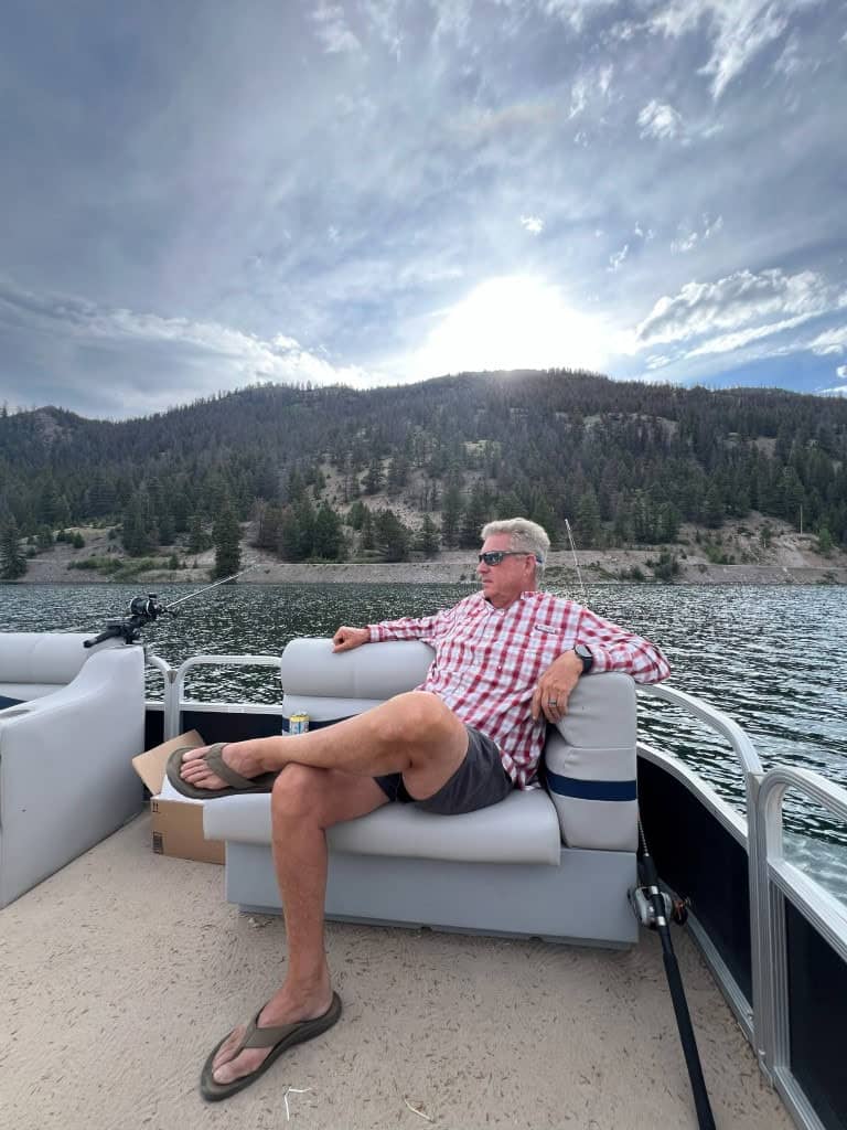 A man relaxes while fishing from Dan's Fly Shop's Pontoon.