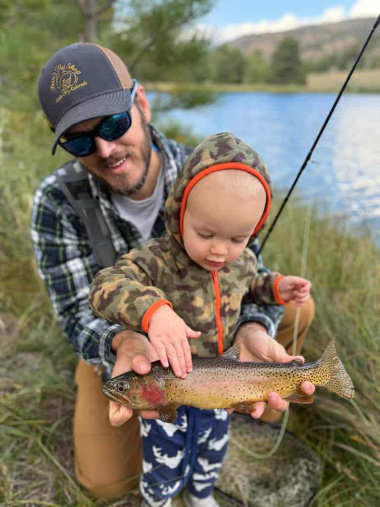 Fishing with family at a scenic river in outdoor gear.