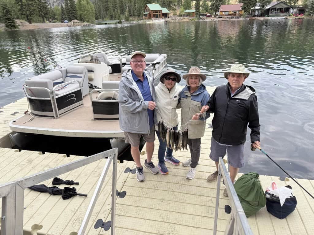 Two couples proudly show off their catch caught from the Dan's Fly Shop pontoon in Lake San Cristobal near Lake City, Colorado.