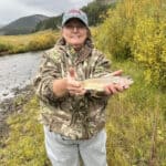 Jennifer B. holds up a nice trout catch.